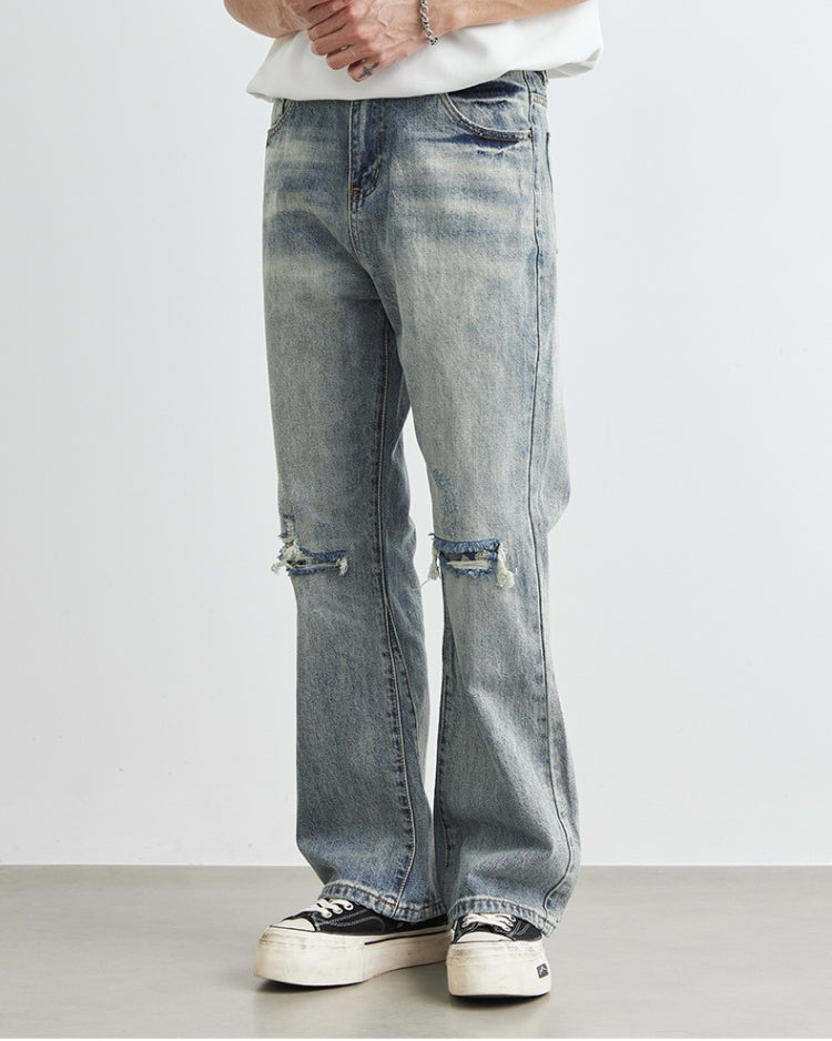 Jeans i denim med vide ben og slitasje