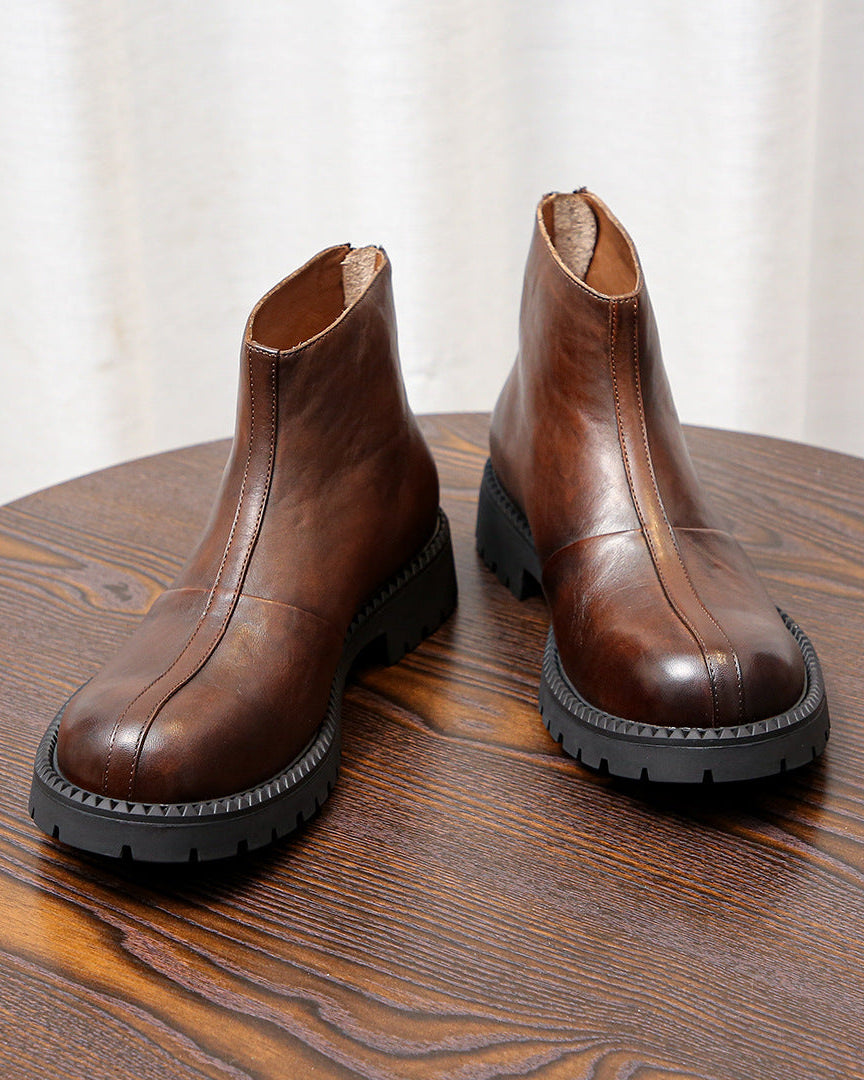As botas de couro robustas com zíper