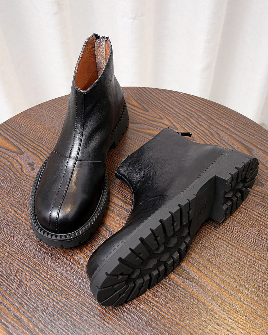 As botas de couro robustas com zíper